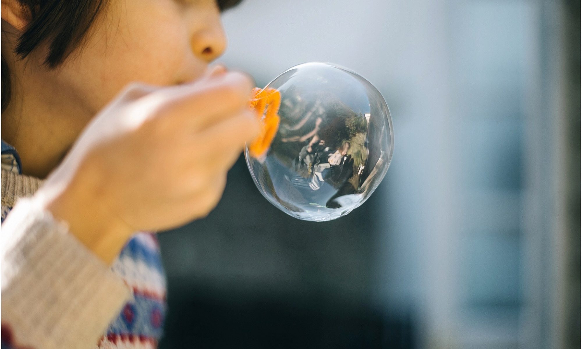 Child Blowing a Soap Bubble