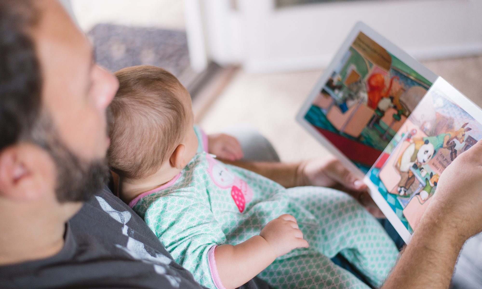 Father reading with baby girl Read with your child